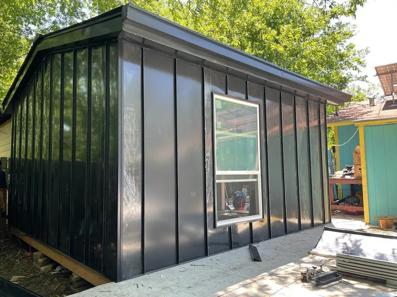 Black standing seam metal wall panels for Roof Inspection in Adel